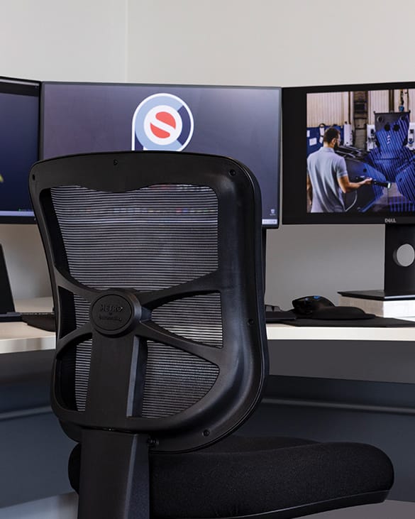 buro metro at desk with three screens