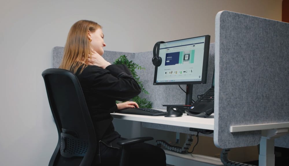 woman with neck pain at her desk