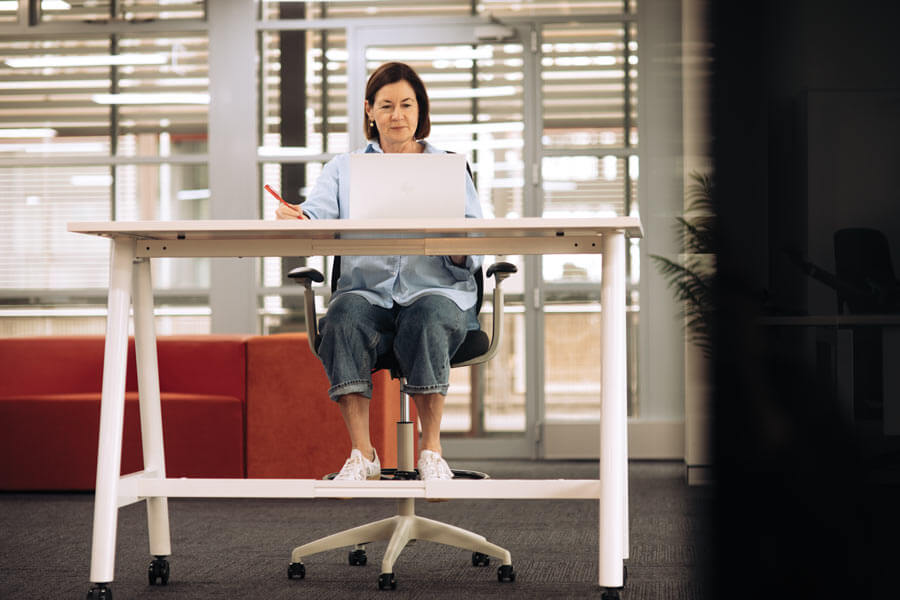 buro force drafting chair woman working at a high table sitting on the buro force drafting chair