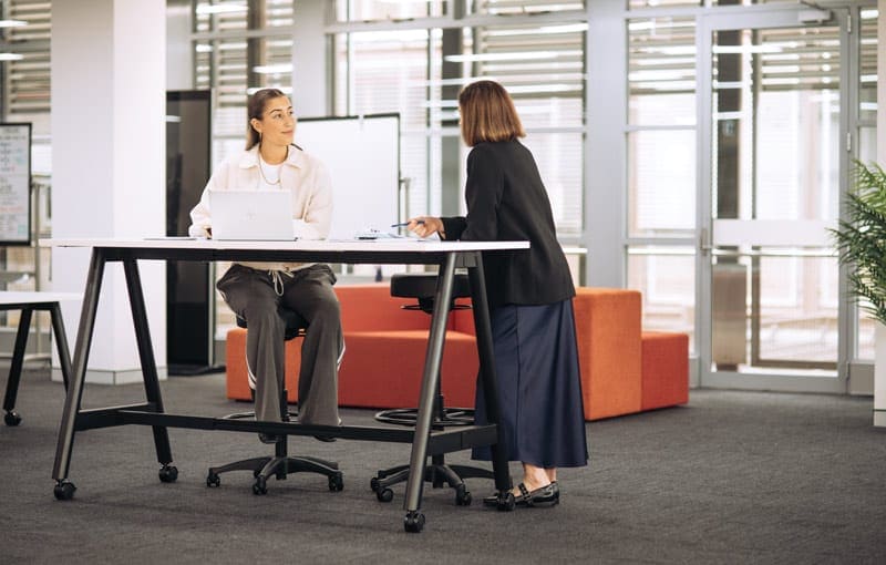 Colleagues work together at a high office table